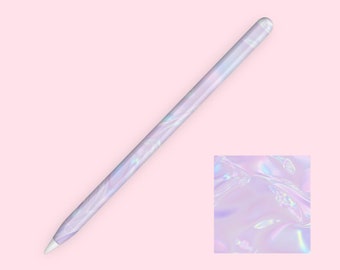 May include: A white and iridescent Apple Pencil with a holographic, pearlescent design. The pencil is on a pink background.