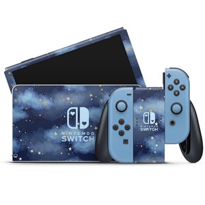 May include: A blue Nintendo Switch console and controller with a starry night sky design. The console has a white cloud and gold stars pattern. The controller has a blue and white starry night design with gold stars.