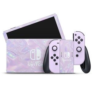 May include: A purple and white Nintendo Switch console and two controllers with a holographic iridescent design. The console has the Nintendo Switch logo and the text "Nintendo Switch".