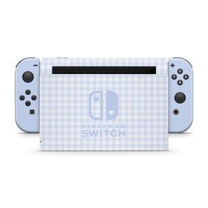 May include: A light blue Nintendo Switch console with a white and light blue gingham pattern. The console has a white Nintendo Switch logo with two hearts.