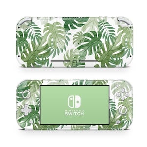 May include: White Nintendo Switch Lite console with a green tropical leaf pattern skin. The console has a green screen and the Nintendo Switch logo is visible.