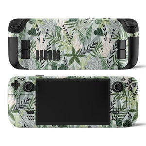 Puede incluir: Una piel con estampado verde y blanco para una consola de juegos portátil. La piel presenta un diseño de hojas tropicales con una variedad de hojas verdes y blancas.