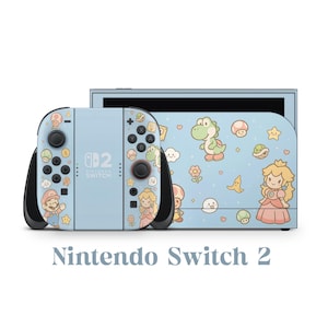 Könnte beinhalten: Eine hellblaue Nintendo Switch 2 Konsole mit passendem Controller. Konsole und Controller sind mit Zeichentrickfiguren wie Mario, Prinzessin Peach und Yoshi sowie Sternen, Herzen und Pilzen verziert. Der Text "Nintendo Switch 2" befindet sich unten.