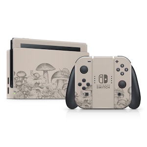 May include: A beige Nintendo Switch console and controller featuring a mushroom and snail design. The console has a screen and a detachable controller. The controller has buttons and a joystick. The design is a black and white illustration of mushrooms and snails.