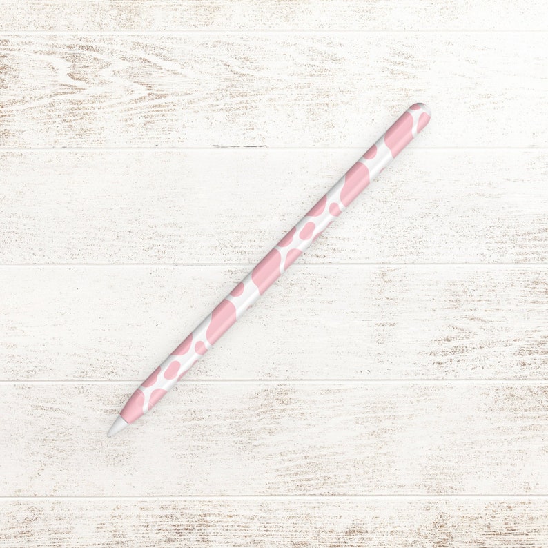 May include: A pink and white patterned stylus for an iPad or tablet.