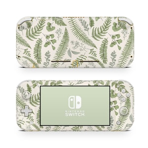 Könnte beinhalten: Eine weiße Nintendo Switch Lite Konsole mit einem grünen und weißen Farnmuster. Die Konsole hat einen grünen Bildschirm und das Nintendo Switch Logo ist auf dem Bildschirm sichtbar.