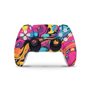 May include: A white PlayStation 5 DualSense controller with a colourful, abstract design. The design features swirls of pink, blue, yellow and orange.