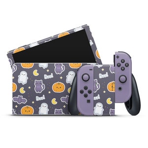 May include: Purple and black Nintendo Switch console with a Halloween themed skin featuring ghosts, pumpkins, cats, and the word "Boo!"