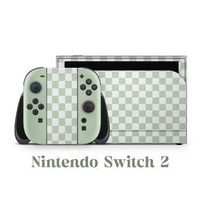 May include: A Nintendo Switch console and controllers with a green and white checkered pattern. The controllers have black accents and buttons. The text "Nintendo Switch 2" is displayed below the console.