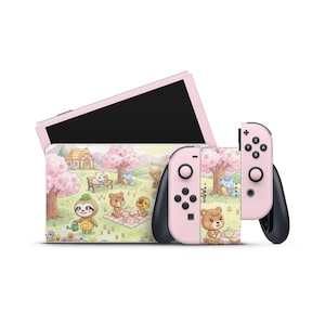 May include: A pink Nintendo Switch console with matching Joy-Con controllers. The console and controllers feature a colourful illustration of cartoon animals in a park setting with cherry blossom trees. The screen is black.