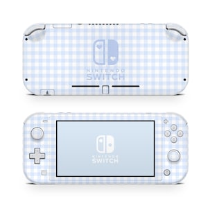 May include: A white Nintendo Switch Lite console with a blue and white gingham pattern. The Nintendo Switch logo is in the center of the console with a heart on each side of the logo. The text "NINTENDO SWITCH" is below the logo.