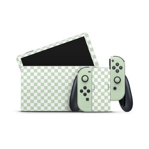 May include: A green and white chequered Nintendo Switch console and controller. The console is closed and the controller is detached.