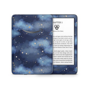 May include: A blue and gold Kindle Paperwhite e-reader case with a starry night sky and clouds design. The case has a quote from the book "The Wheel of Time" by Robert Jordan: "There are neither beginnings nor endings to the Wheel of Time. But it was a hard thing to say."