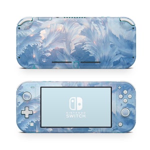 May include: A blue and white Nintendo Switch Lite console with a frosty, icy design. The console features the Nintendo Switch logo and the text "NINTENDO SWITCH".