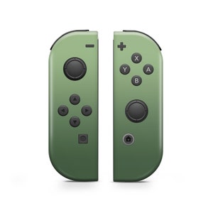 May include: A pair of green Nintendo Switch Joy-Con controllers. The left Joy-Con has a directional pad and four buttons. The right Joy-Con has four face buttons, a joystick, and a home button.