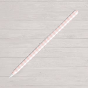 May include: A pink and white gingham Apple Pencil skin. The skin is made from a durable vinyl material and is designed to protect the Apple Pencil from scratches and scuffs.