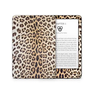May include: A Kindle e-reader with a leopard print cover. The screen displays the text "Chapter 1" and "Flame of Tar Valon".