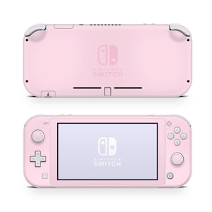 May include: A pink Nintendo Switch Lite handheld gaming console with a white Nintendo Switch logo and the text "NINTENDO SWITCH" on the back. The console has a white screen and white buttons.