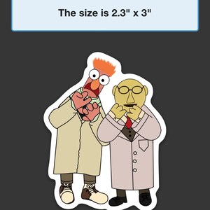 May include: A sticker featuring two Muppet characters, a red-haired character with a green shirt and a yellow-skinned character with a red tie, both wearing white lab coats and looking surprised. The sticker is 2.3 inches by 3 inches.
