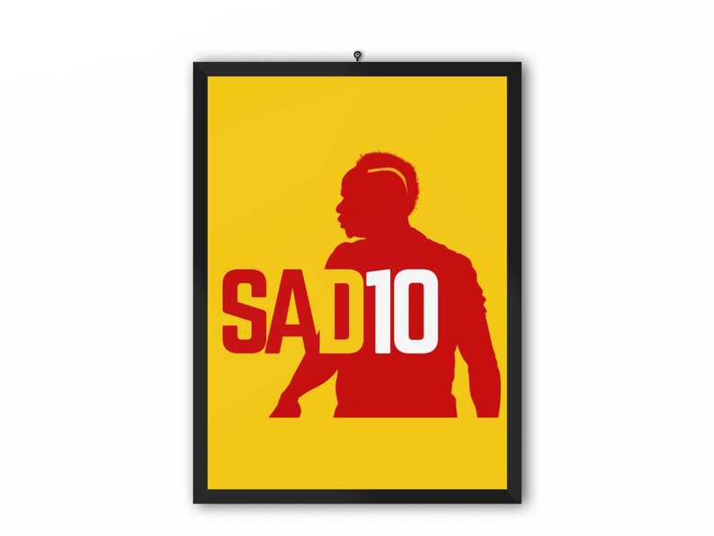 May include: A yellow poster with a red silhouette of a soccer player with the text "SAD10" in white.