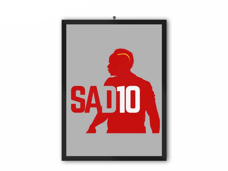 May include: A red silhouette of a soccer player with the number 10 and the word "SAD" in white letters on a gray background.
