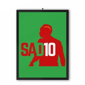 May include: A green and red poster with a silhouette of a soccer player wearing the number 10. The text "SAD10" is printed in white on the poster.