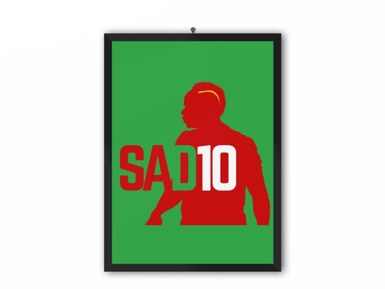 May include: A green and red poster with a silhouette of a soccer player wearing the number 10. The text "SAD10" is printed in white on the poster.