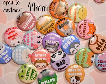 May include: A collection of 44mm round pin-back buttons featuring various colorful cartoon animals and text related to disabilities and mental health conditions. The buttons include phrases like I have ADHD, I have anxiety, and I have a stutter.