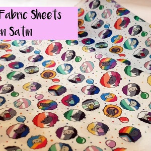 May include: A sheet of white fabric with a repeating pattern of colorful sheep with rainbow flags. The fabric is labeled "A4 Fabric Sheets Linen Satin".