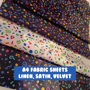 May include: Three A4 fabric sheets in linen, satin, and velvet. Each sheet features a black background with a colorful geometric pattern.