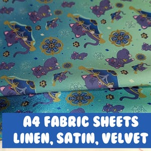 May include: A4 fabric sheets in linen, satin, and velvet with a repeating pattern of a black cat holding a golden staff with a blue flag. The background is a gradient of blue and green.