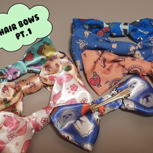 May include: Five colorful hair bows with different patterns. The bows are made of satin and have a variety of designs, including ghosts, flowers, and hearts. The bows are attached to alligator clips.