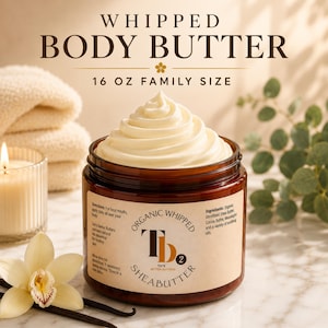 May include: A 16 oz amber glass jar of organic whipped body butter with a cream-colored, swirled top. The label features the text "Organic Whipped Tb2 Tee's Better Butters Sheabutter" along with directions and ingredients listed on the side.