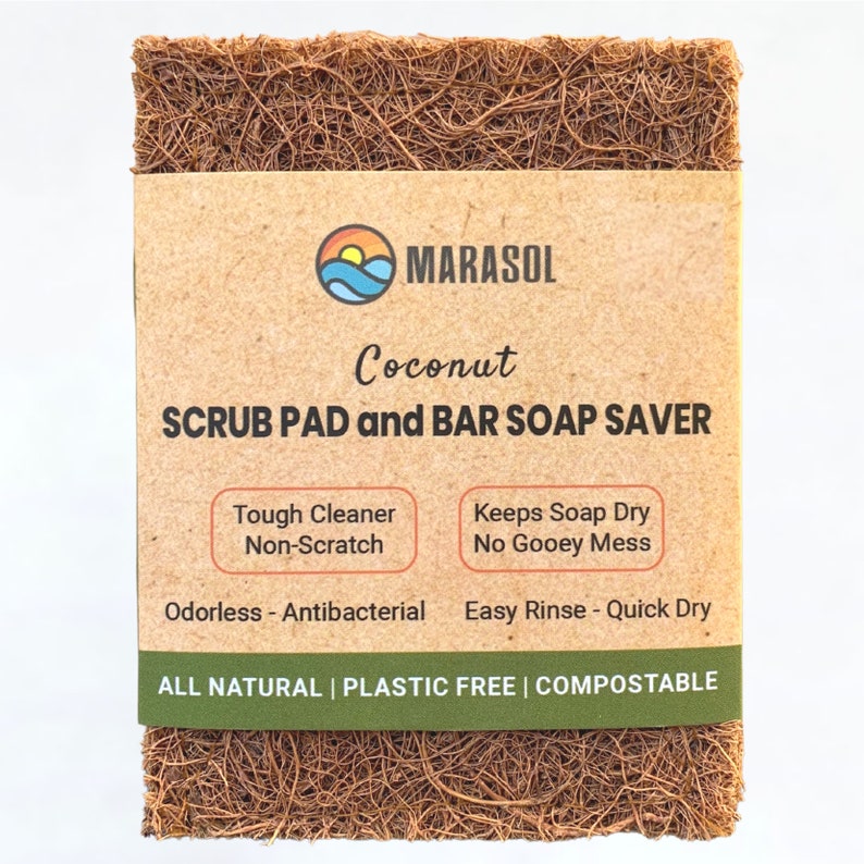 K&ouml;nnte beinhalten: Ein brauner Kokosnuss-Schrubbpad und ein Seifenhalter f&uuml;r feste Seife. Die Verpackung ist braun mit dem Text "MARASOL Coconut SCRUB PAD and BAR SOAP SAVER" und listet die Vorteile des Produkts auf: "Tough Cleaner Non-Scratch Odorless - Antibacterial Keeps Soap Dry No Gooey Mess Easy Rinse - Quick Dry ALL NATURAL | PLASTIC FREE | COMPOSTABLE".