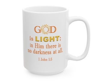 May include: White ceramic mug with a gold and orange design that reads "GOD is LIGHT: in Him there is no darkness at all. 1 John 1:5".