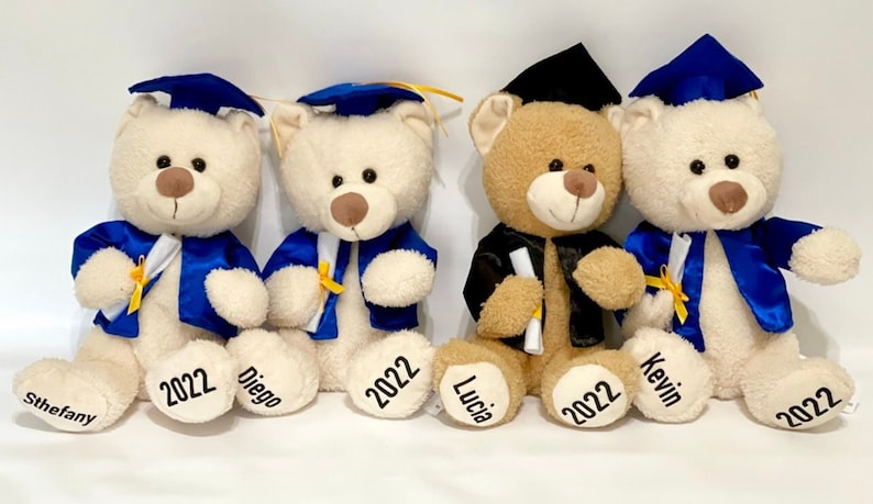Four stuffed bears in graduation cap and gowns