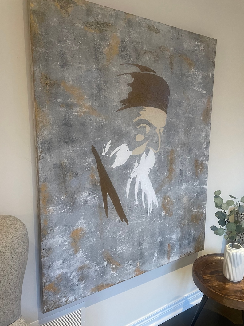 May include: Abstract painting on canvas featuring a stylized portrait of a person with a beard. The background is a textured gray with brown and white accents.