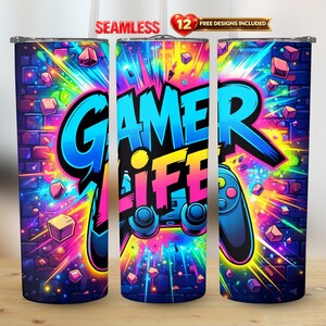May include: A tall, cylindrical tumbler with a vibrant design. The tumbler features the words "GAMER LIFE" in bold, colorful text, along with a game controller graphic. The background is a brick wall with a burst of neon colors and geometric shapes.