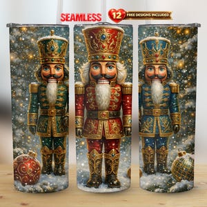 May include: Three stainless steel tumblers with a festive nutcracker design. Each tumbler features a detailed illustration of a nutcracker soldier in a colorful uniform, set against a snowy background with ornaments. The tumblers are approximately 8 inches tall.