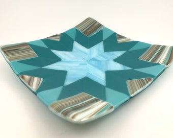 178-Fused glass "Virginia Star" quilt square with a sky blue and teal star design on a turquoise and striped brown background