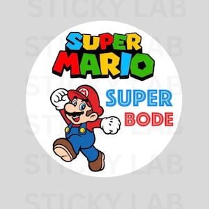 May include: A round sticker featuring the Super Mario character in a running pose. The sticker has the words "SUPER MARIO" in colorful text at the top and "SUPER BODE" in blue and red text below the character.