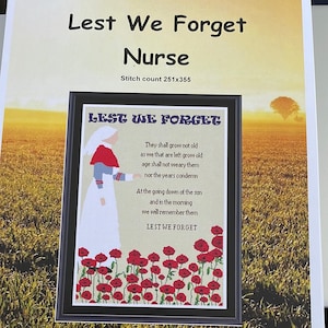 May include: Cross-stitch pattern for a framed image of a nurse in a white uniform and red poppy flowers. The text reads "Lest We Forget" and includes a poem about remembering those who have died in war. The stitch count is 251x355.
