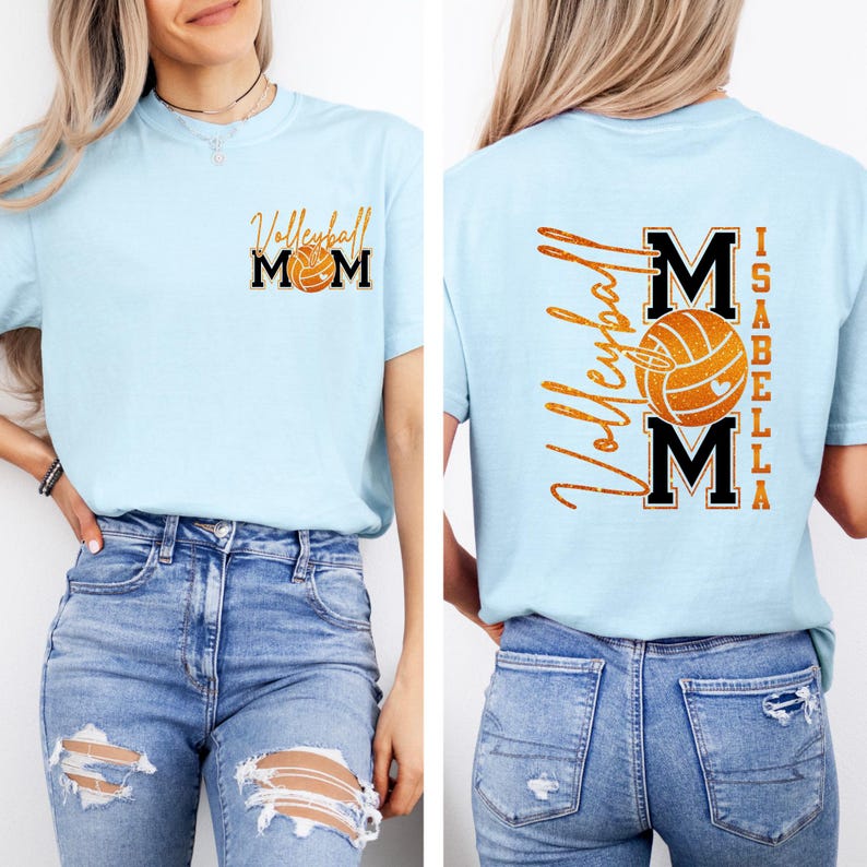 May include: Light blue t-shirt with "Volleyball Mom" and a volleyball graphic on the front. The back of the shirt features "Volleyball" and "MOM" with a volleyball graphic, and the name "Isabella".