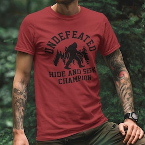 Bigfoot Hide And Seek Champion Shirt, Undefeated Sasquatch Tee, Funny Camping Shirt, Outdoor Adventure Graphic Tee, Cryptid Humor Gift image 1