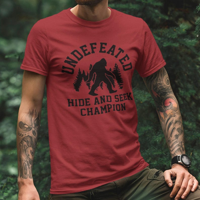 Bigfoot Hide And Seek Champion Shirt, Undefeated Sasquatch Tee, Funny Camping Shirt, Outdoor Adventure Graphic Tee, Cryptid Humor Gift image 1