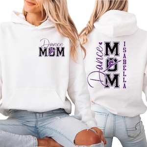 May include: White hoodie with a front pocket and a purple and black "Dance Mom" graphic. The back of the hoodie features the text "Dance Mom Isabella" in a similar design. The hoodie is made of a soft material.