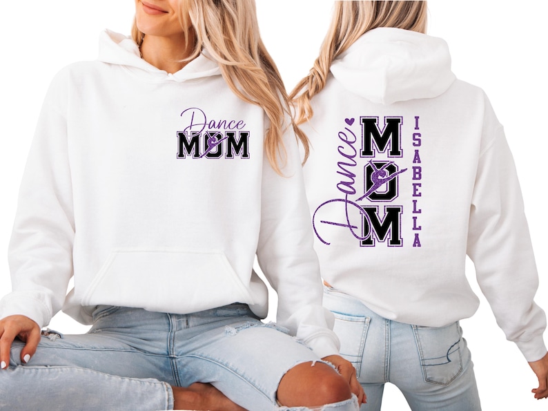 May include: White hoodie with a front pocket and a purple and black "Dance Mom" graphic. The back of the hoodie features the text "Dance Mom Isabella" in a similar design. The hoodie is made of a soft material.