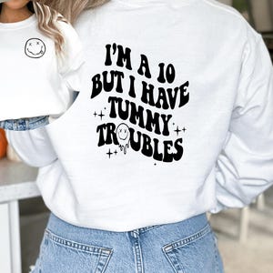 I’m a 10 but I have tummy troubles || tummy problems || front and back graphic || tummy problem graphic sweater