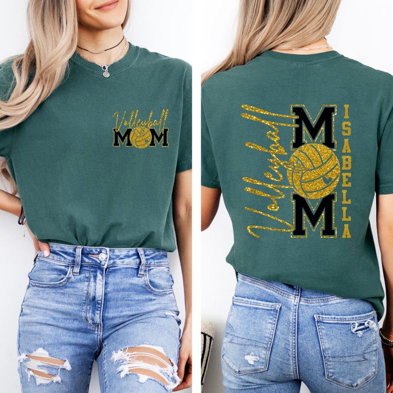 May include: Teal short-sleeved t-shirt with a gold glitter volleyball graphic and the text "Volleyball Mom" on the front. The back of the shirt features the text "Volleyball Mom" and the name "Isabella".