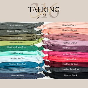 a collection of 16 different colored t-shirts arranged in a grid-like pattern, with each t-shirt having a unique color.